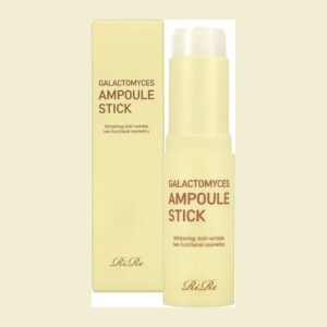 RiRe Galactomyces Ampoule Stick pale yellow twist-up stick, uncapped, beside its yellow box
